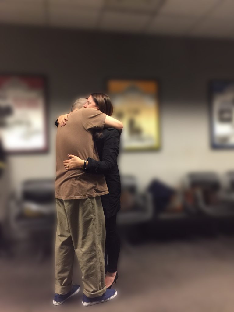Wife hugging husband after being released from prison